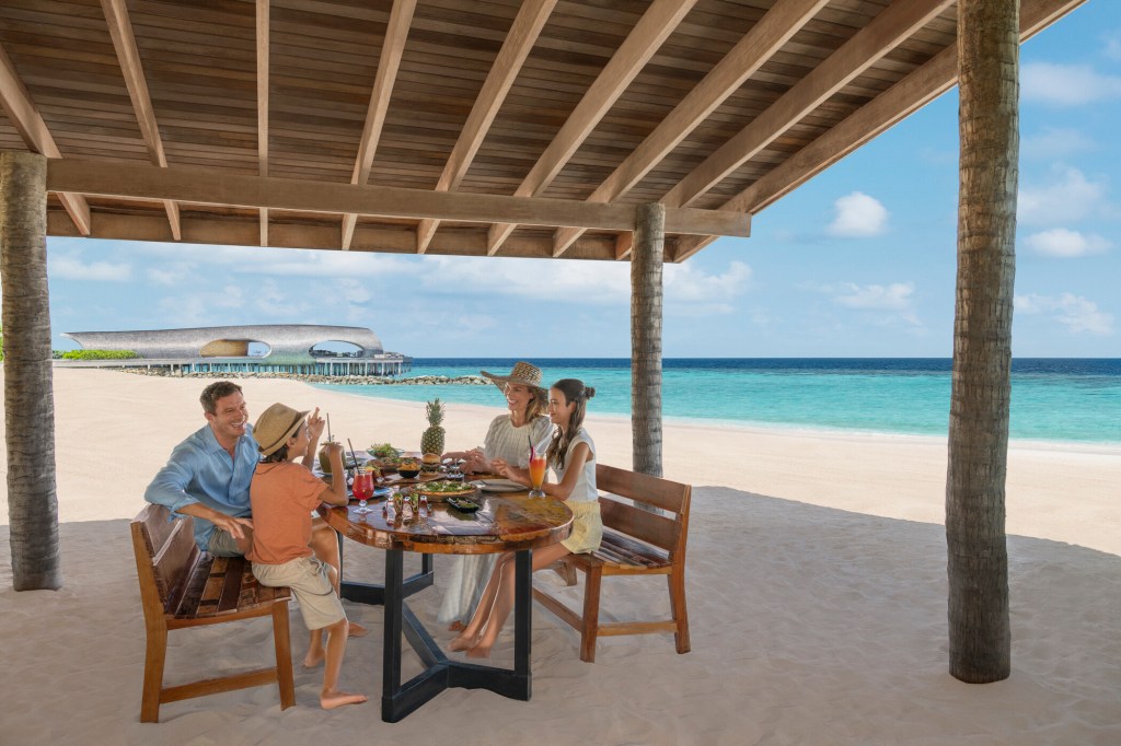 Family eating lunch on the Maldives beach